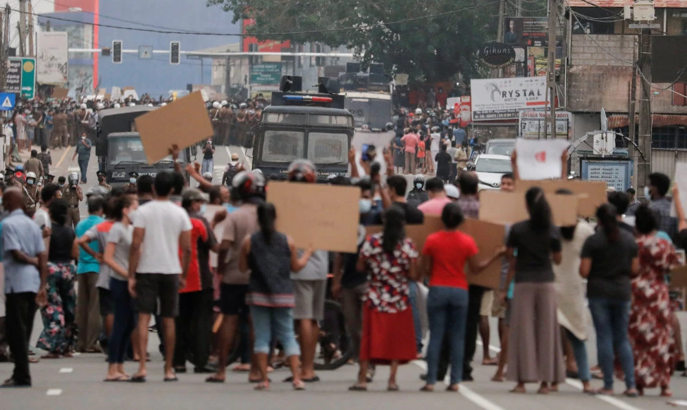 People attend a protest against Sri Lankan President Gotabaya Rajapaksa in a residential area after the government imposed a curfew following a clash between police and protestors in Colombo, Sri Lanka April 3, 2022. (Reuters)