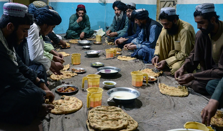 Members of the Taliban break their iftar fast on the first day of the holy month of Ramadan in Kandahar on April 2, 2022. (AFP)