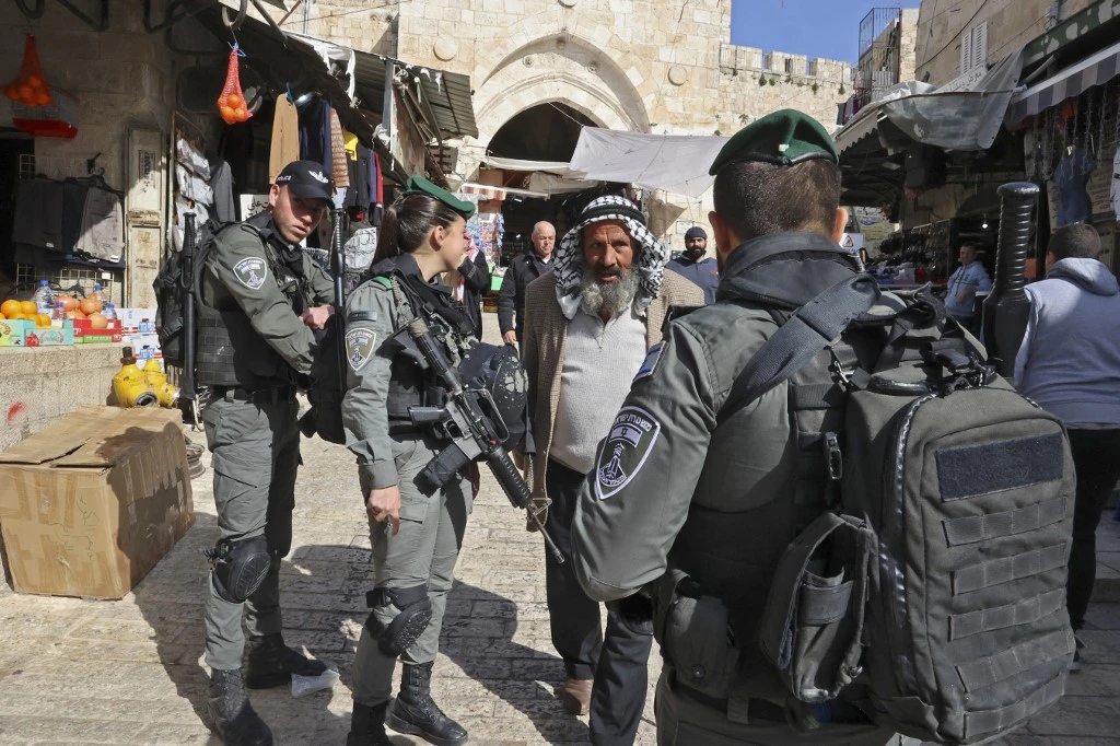 Israeli security forces check Palestinians heading to the Al-Aqsa mosque compound for Friday prayers on April 1, 2022 in the Old City of Jerusalem. (AFP)