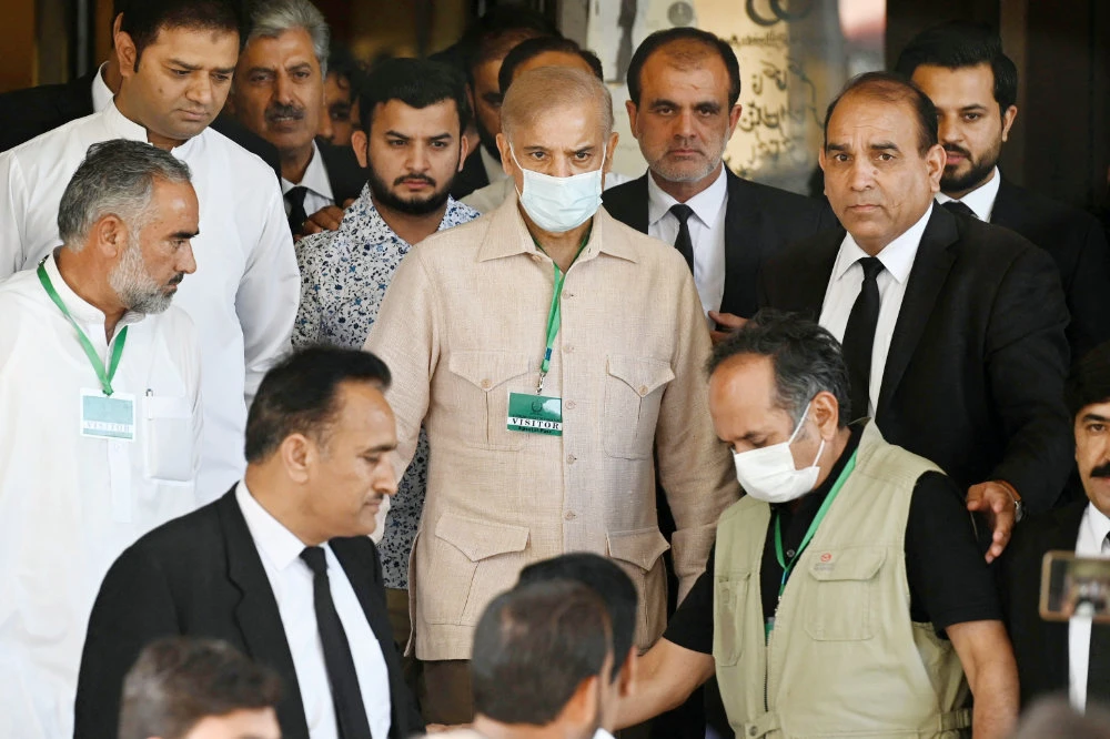 Pakistan’s opposition leader Shahbaz Sharif, center, leaves with his supporters the Supreme Court following a petitions hearing to dissolve parliament. (AFP)