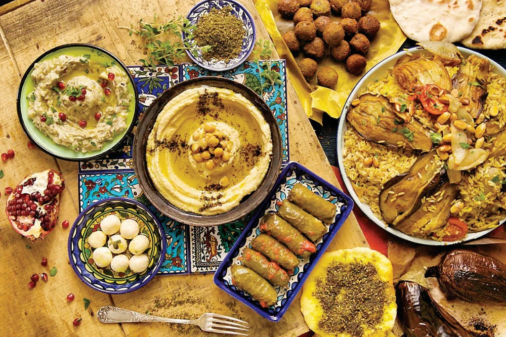 With constant unrest and displacement, refugees from different Palestinian cities share their cities’ famous dishes with one another. Maqluba, the national dish of Palestine, is enjoyed by all. (Supplied)
