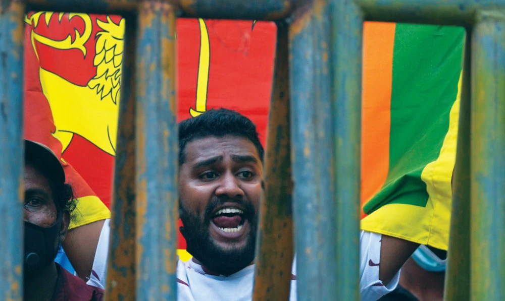 A Sri Lankan man shouts slogans during a protest in Colombo on Tuesday. (AP)