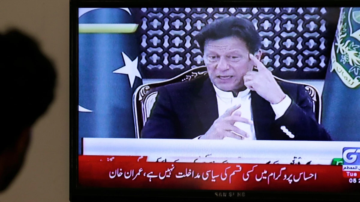 Pakistanis watch as Imran Khan makes an address to the nation. (Reuters)