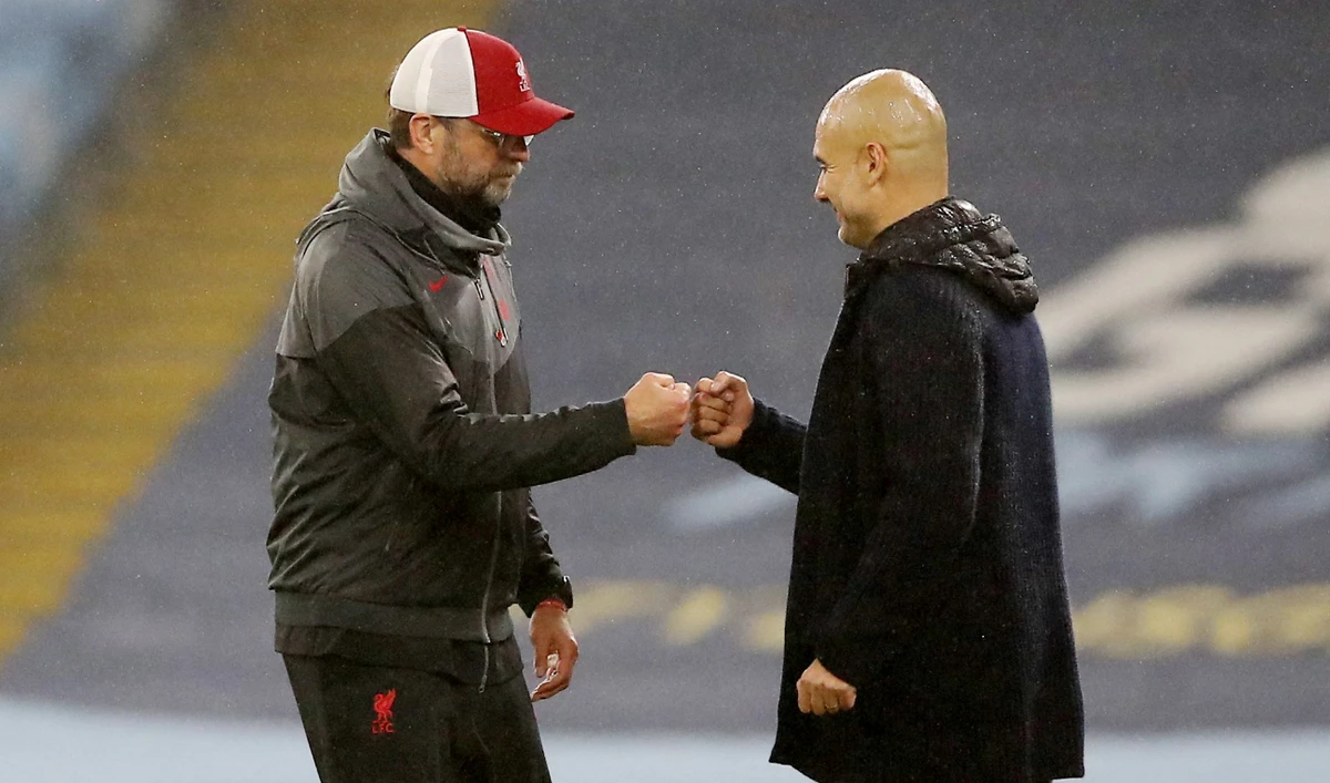 Manchester City manager Pep Guardiola and Liverpool manager Juergen Klopp bump fists after their Premier League match on November 8, 2020 at Etihad Stadium. (Reuters/File)