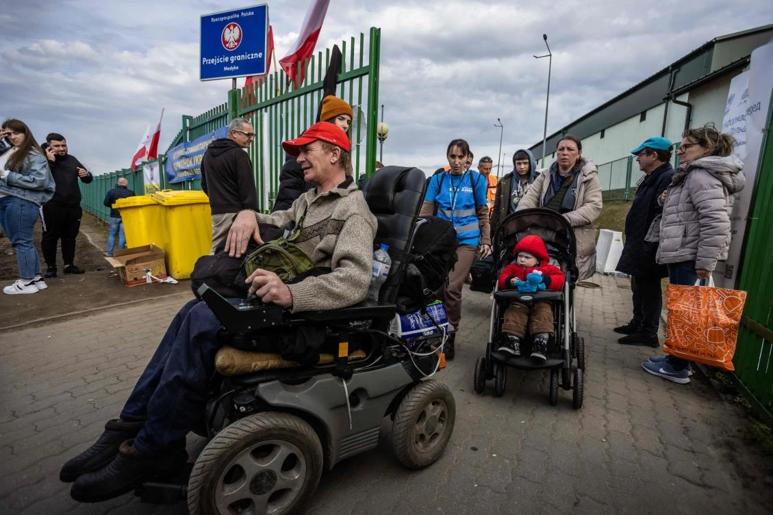 Refugees from Ukraine are seen at the Polish/Ukrainian border crossing in Medyka on Thursday. (AFP)