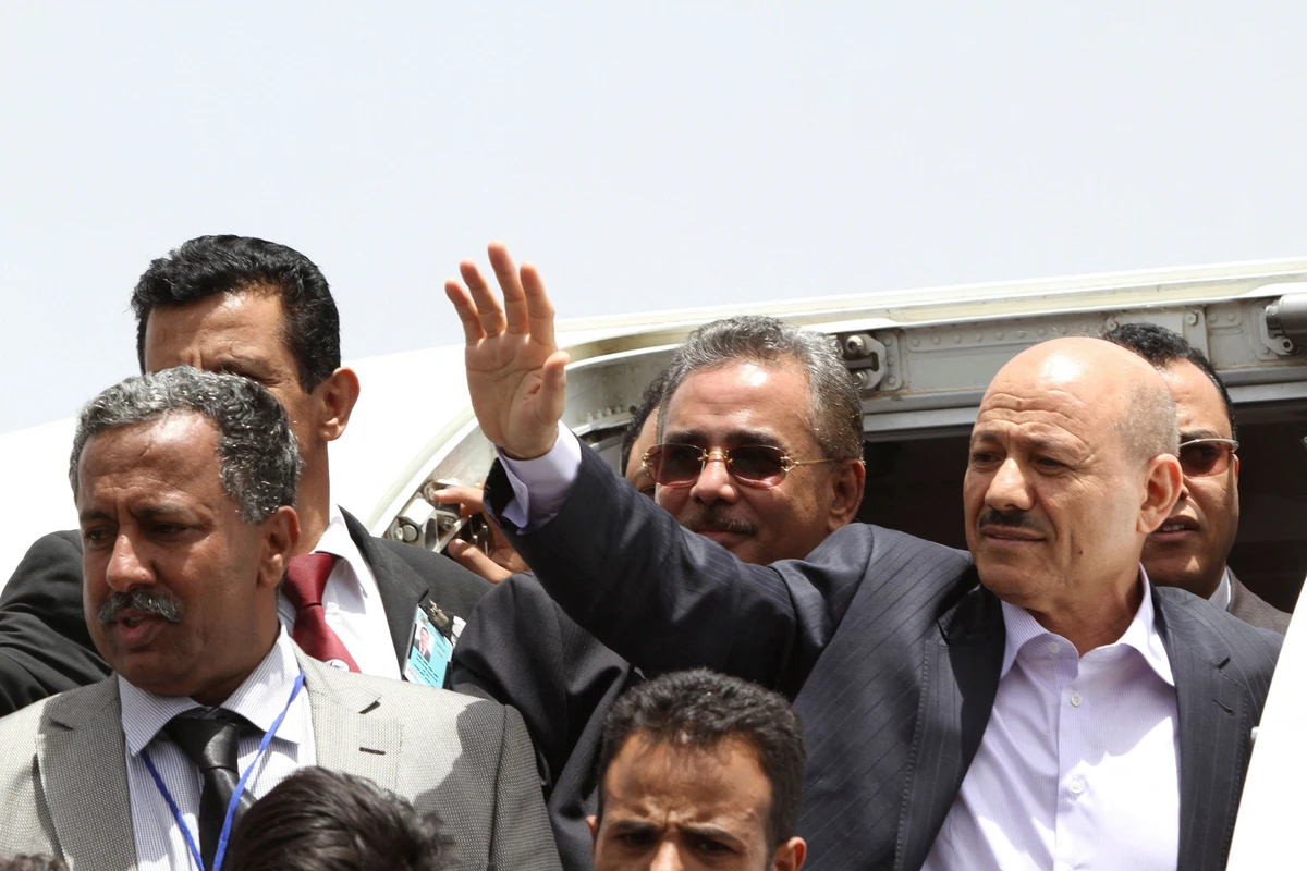 Rashad Al-Alimi, then deputy prime minister for security affairs, waves as he arrives at Sanaa airport on June 13, 2012. (Reuters)