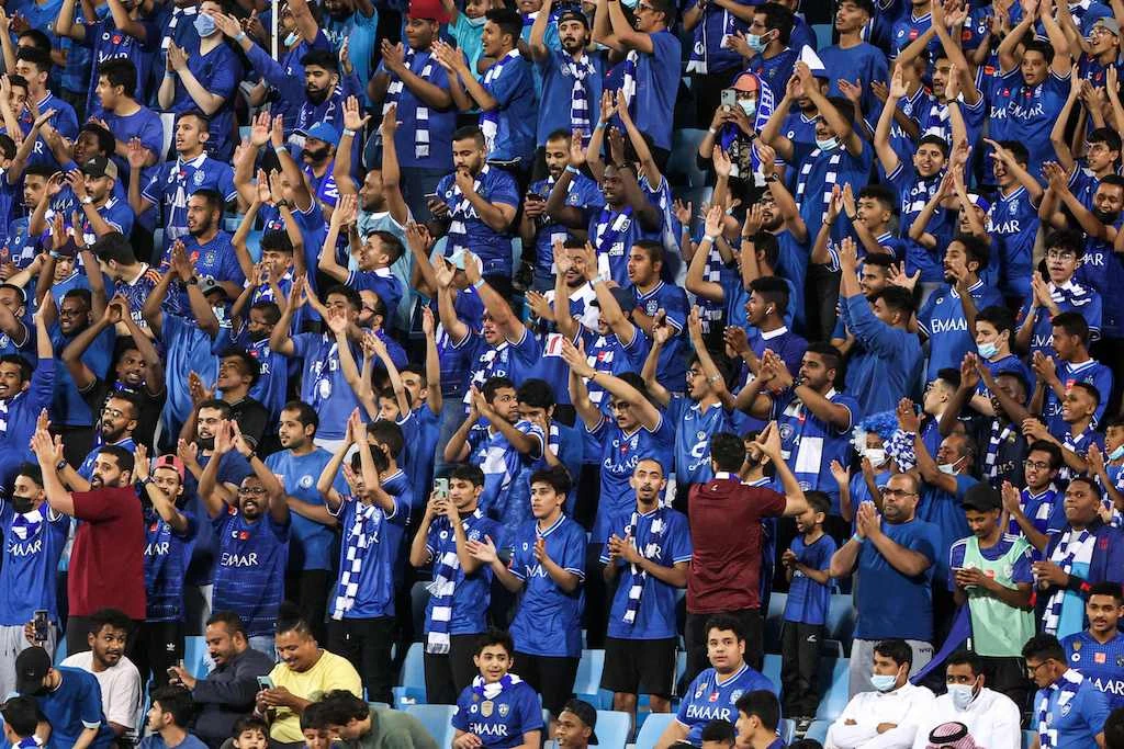 Supporters of al-Hilal Saudi Football Club cheer for their team during the AFC Champions League Group A match between al-Hilal and Sharjah at Prince Faisal bin Fahd Stadium in Riyadh on April 8, 2022. (AFP)