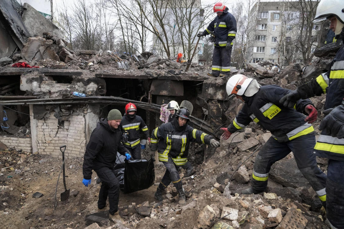 Emergency workers remove the body of a resident of a multistory building destroyed in an air raid in Borodyanka, close to Kyiv, Ukraine on April 9, 2022. (AP)