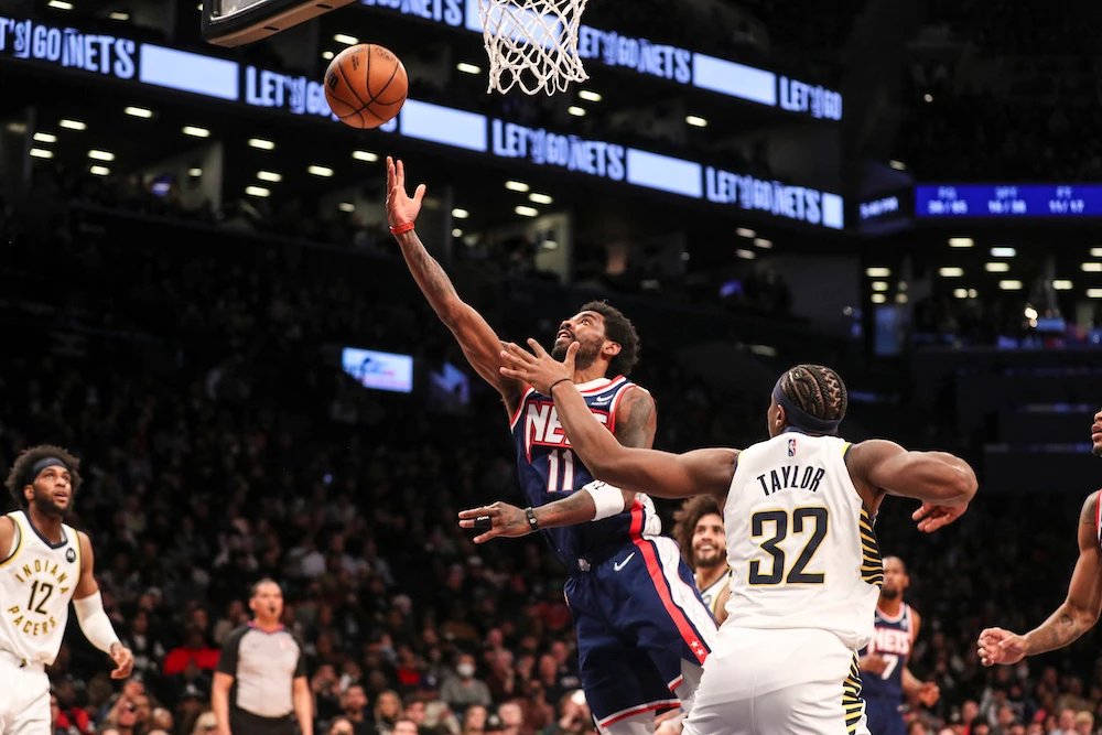 Brooklyn Nets guard Kyrie Irving drives past Indiana Pacers guard Terry Taylor for a layup in the fourth quarter of their NBA game at Barclays Center on Sunday. (USA TODAY Sports)