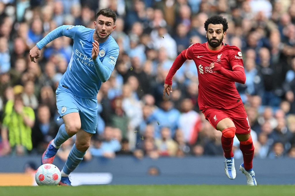 Liverpool’s Mohamed Salah, right, vies with Manchester City’s Aymeric Laporte during their English Premier League match on April 10, 2022. (AFP)
