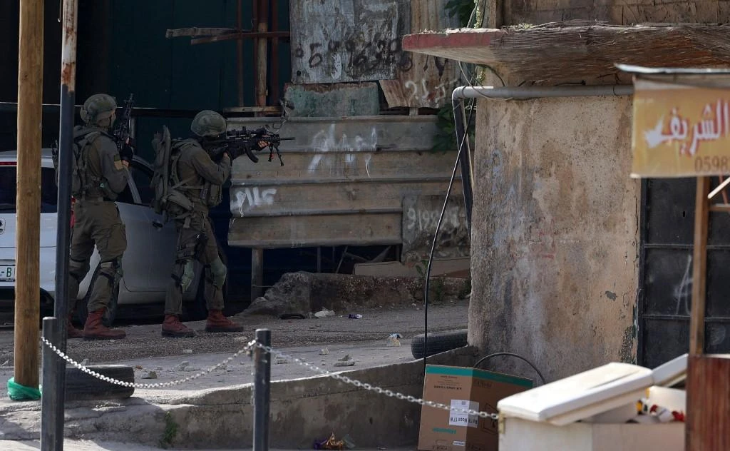 Israeli troops take position in the Nur Shams Palestinian refugee camp on April 10,2022 during a raid looking for suspects related to a shooting rampage in a popular Tel Aviv nightlife area. (AFP)