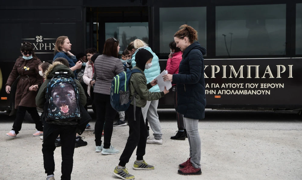 Ukrainian refugees welcome their children as they come back from school at Serres refugee camp, northern Greece. (AFP)