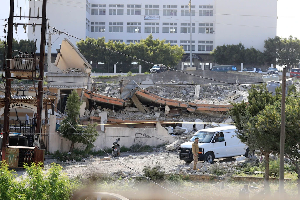 Lebanese security inspect the damage after an explosion in the town of Banaafoul near the port city of Sidon, Lebanon, Tuesday, April 12, 2022. (AFP)
