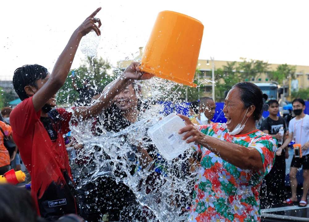 People play with water as they celebrate during the Songkran holiday which marks the Thai New Year during the coronavirus disease (COVID-19) outbreak, in Bangkok, Thailand, April 13, 2022. (Reuters)