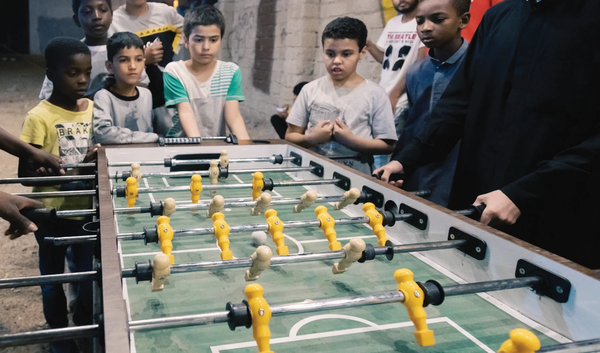 Children from the neighborhood enjoy playing foosball, a popular game traditionally played with gusto during Ramadan nights. (Supplied)