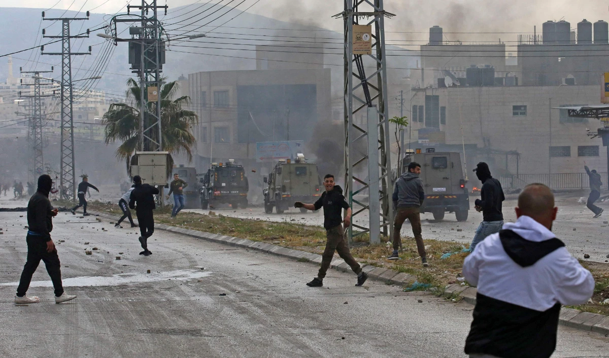 Israeli troops and Palestinians clash near the Jewish pilgrimage site of the Tomb of Joseph in Nablus in the occupied West Bank on April 13, 2022. (AFP/File)