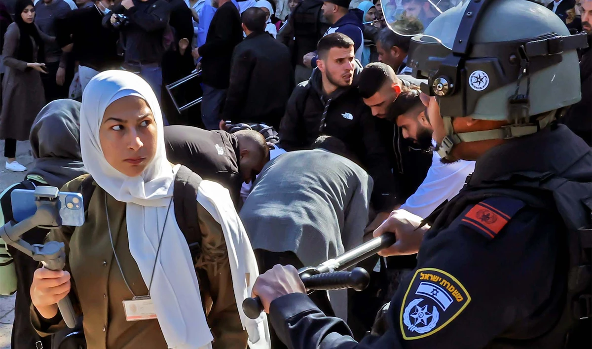 Israeli security forces prevent Palestinians from entering the al-Aqsa mosque compound to attend the Friday prayers, on April 15, 2022. (AFP/File)
