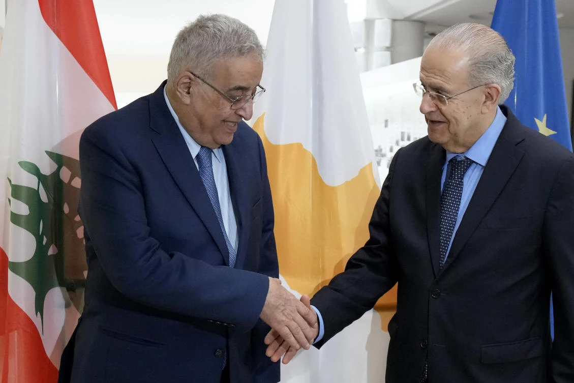 Cyprus’ foreign minister Ioannis Kasoulides shakes hands with his Lebanese counterpart Abdallah Bou Habib before their meeting at the foreign ministry house in Nicosia on Friday. (AP)