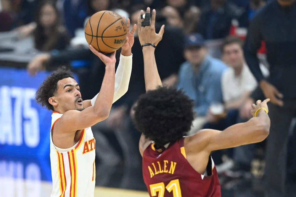 Atlanta Hawks guard Trae Young shoots against Cleveland Cavaliers center Jarrett Allen in their NBA play-in game at Rocket Mortgage FieldHouse on April 15, 2022. (USA TODAY Sports)