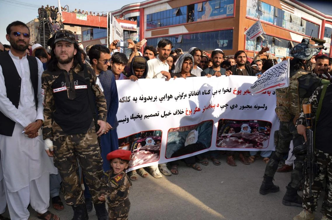 Demonstrators hold a banner during a protest against Pakistani airstrikes, in Khost on April 16, 2022. (AFP)