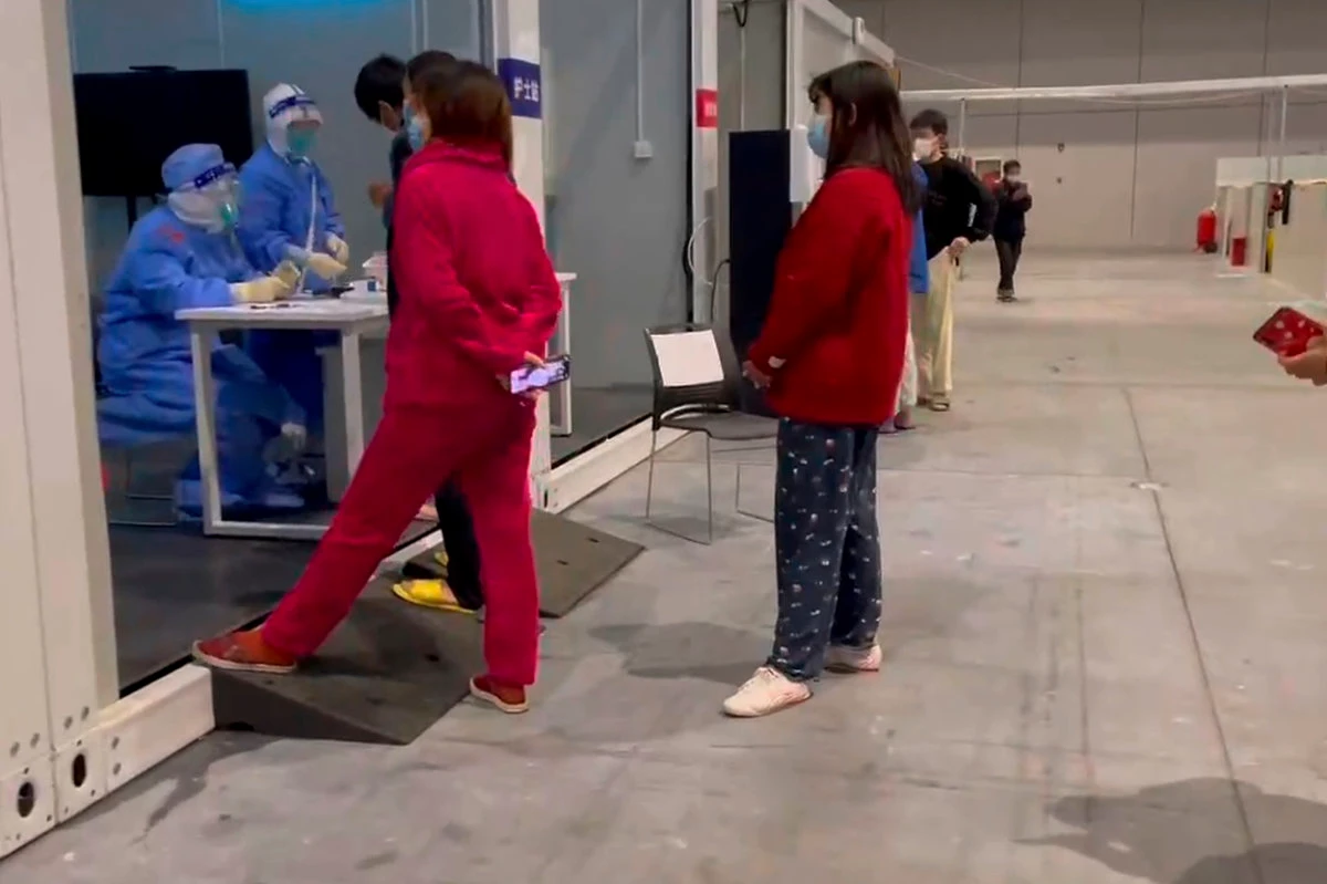 Residents seek medical help at the National Exhibition and Convention Center, which is being used as a coronavirus a quarantine facility in Shanghai. (AP)