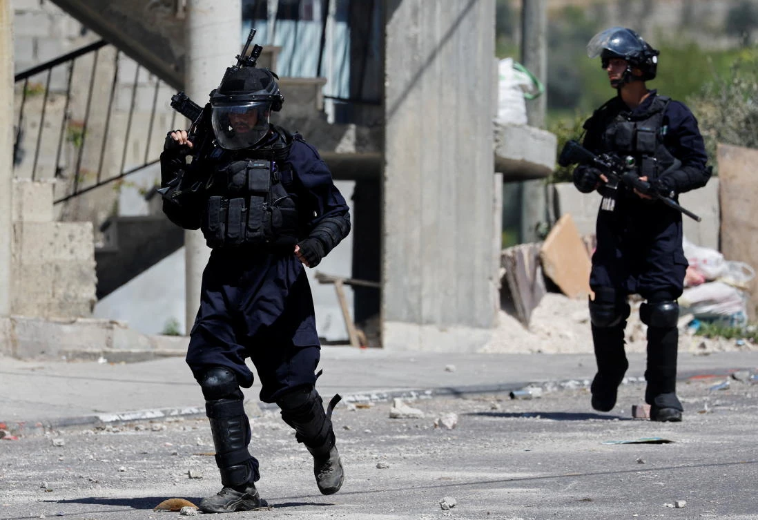 Israeli forces carry weapons during a clash in the Israeli-occupied West Bank April on 14, 2022. (Reuters)