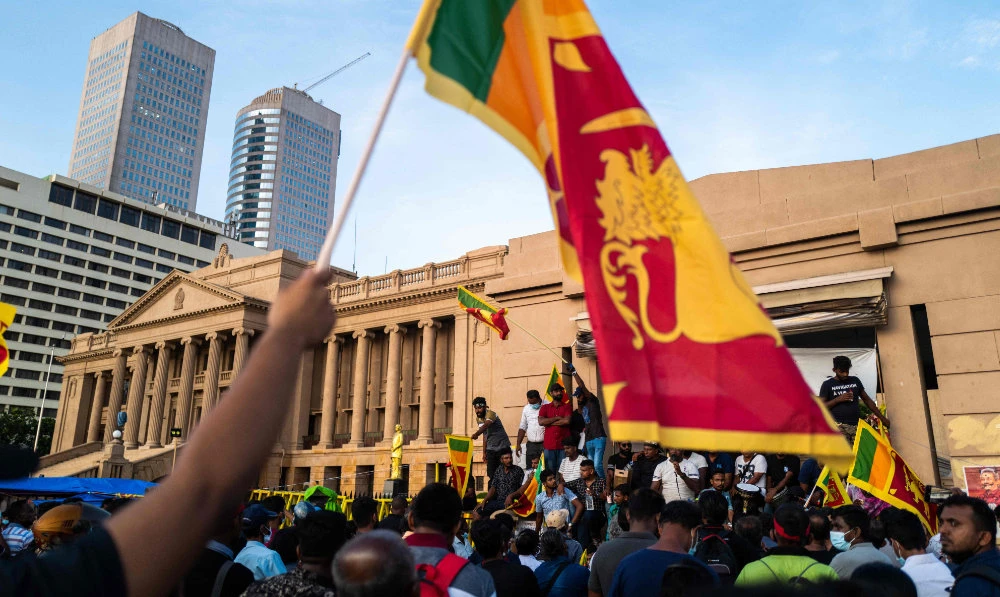 Protesters shout slogans during an ongoing anti-government demonstration near the president's office in Colombo on April 18, 2022, demanding President Gotabaya Rajapaksa’s resignation over the country's crippling economic crisis. (AFP)