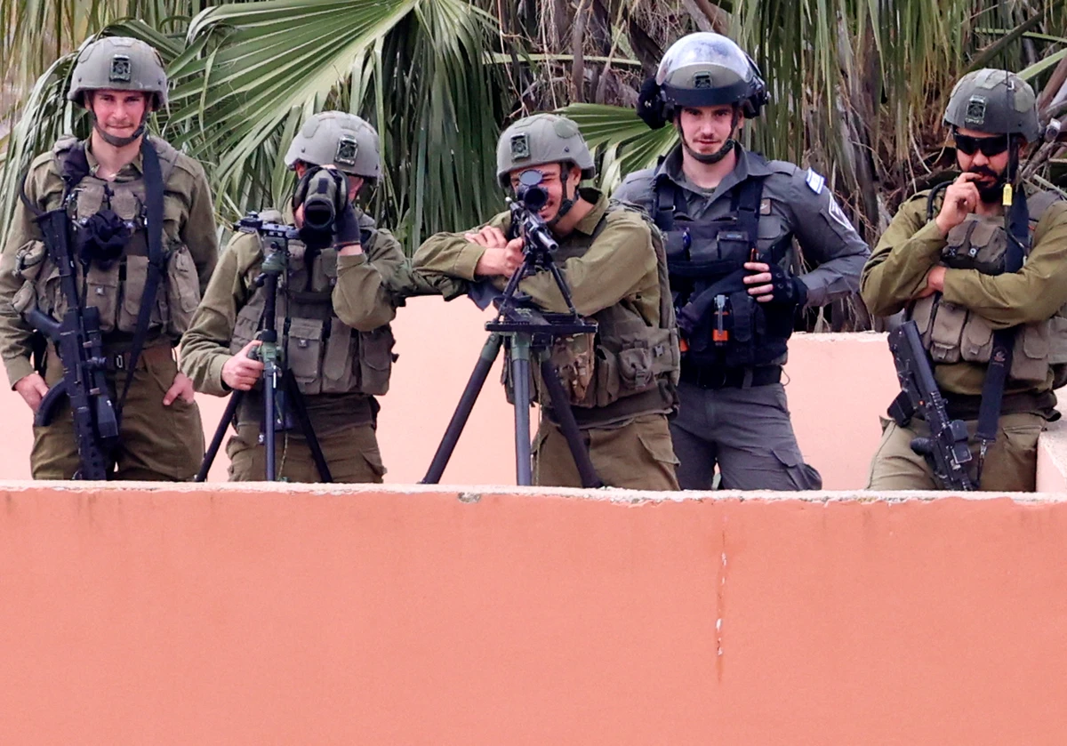 Israeli forces take aim during clashes with Palestinian demonstrators following a protest against a march by Israeli settlers to the wildcat settlement outpost of Homesh, Burqa, West Bank on April 19, 2022. (AFP)