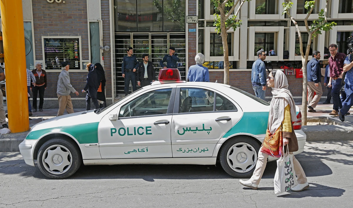 An Iranian police vehicle is seen parked outside a currency exchange shop in the capital Tehran on April 10, 2018. (AFP/File)