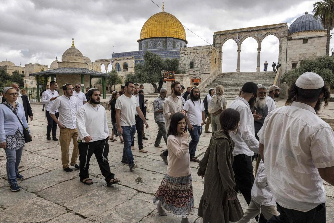 A group of religious Jewish men and women walk past the Dome of the Rock during their visit to the Temple Mount, which is known to Muslims as the Haram Al-Sharif, at Al-Aqsa mosque compound in Jerusalem on Wednesday. (AFP)