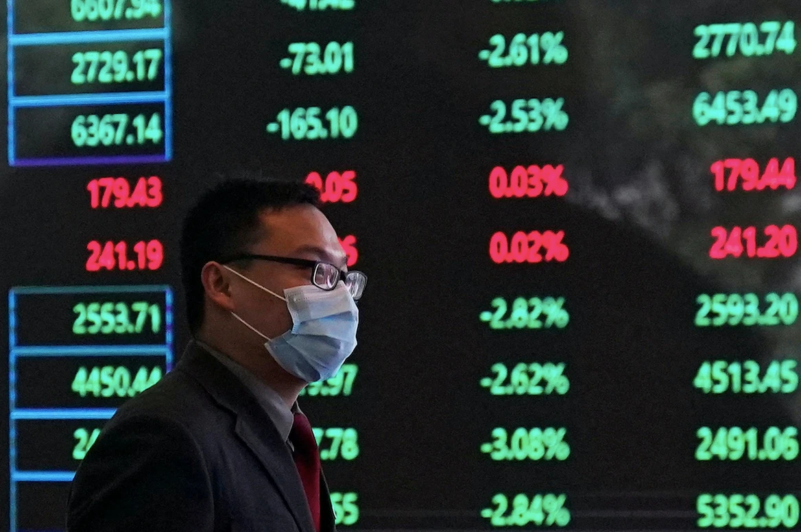 A man wearing a protective mask is seen inside the Shanghai Stock Exchange building at the Pudong financial district in Shanghai (File/Reuters)