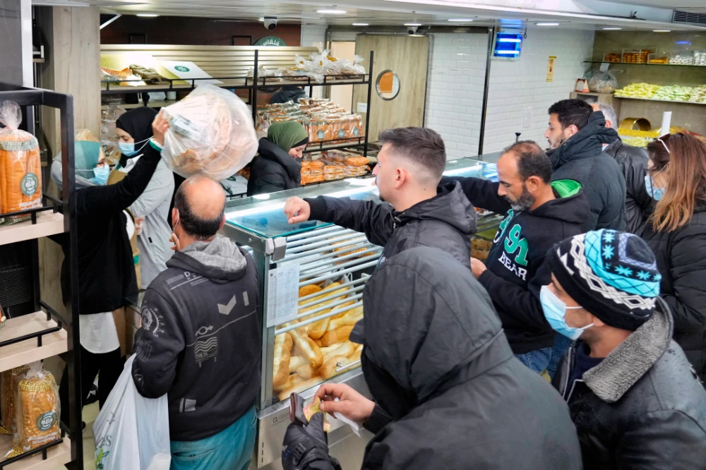People queue for bread inside a bakery in the southern Beirut suburb of Dahiyeh, Lebanon. (AP file photo)