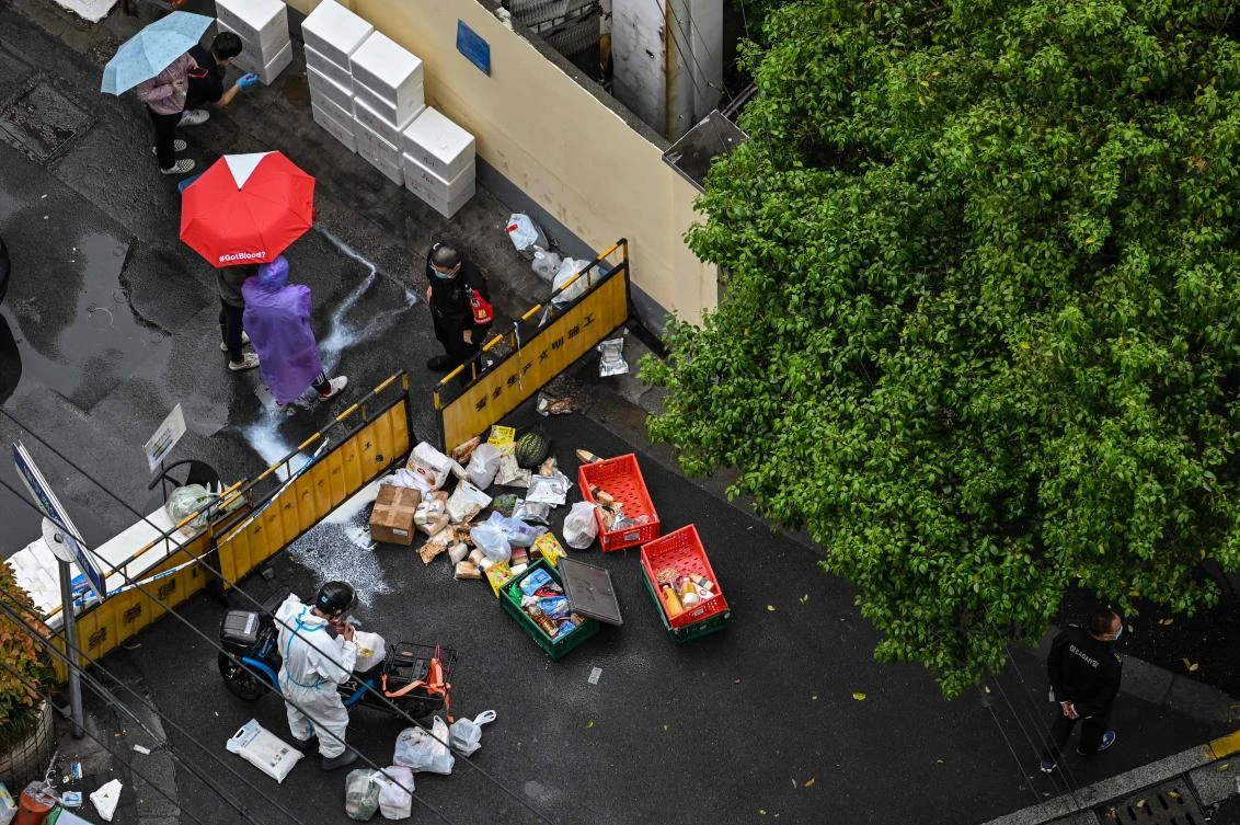 Images of white hazmat suit-clad workers sealing entrances of housing blocks and even closing off entire streets with roughly two-meter-tall green fencing went viral on social media. (AFP)