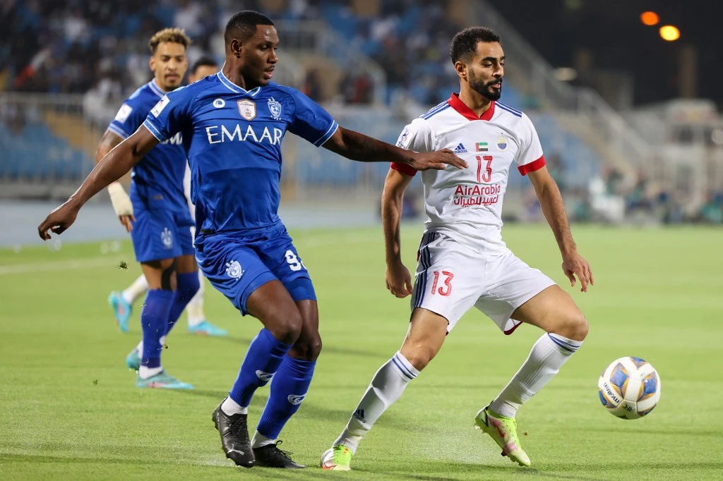 Hilal's midfielder Odion Ighalo (L) vies for the ball with Sharjah's defender Salem Sultan during the AFC Champions League group A match between UAE's Sharjah and Saudi Arabia's al-Hilal on April 23, 2022. (AFP)