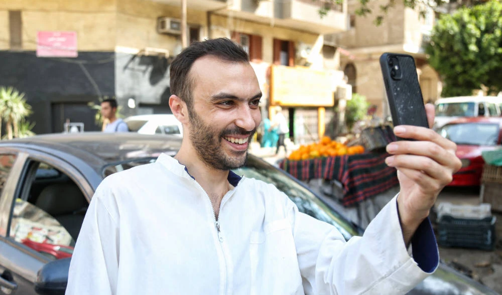 Egyptian doctor and political activist Walid Shawky talks on the phone in Cairo following his release from the police station in al-Abassya district, on April 24, 2022. (AFP)