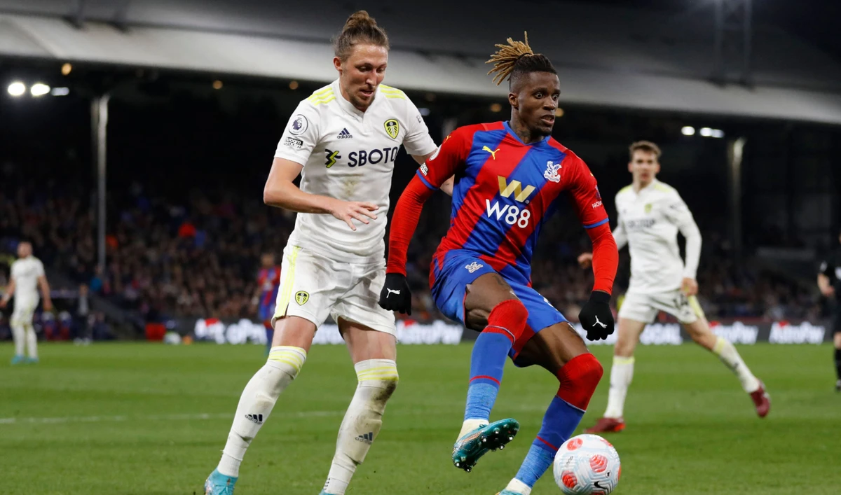 Leeds United's English defender Luke Ayling (L) vies with Crystal Palace's Ivorian striker Wilfried Zaha during their English Premier League football match at Selhurst Park in south London on April 25, 2022. (AFP)