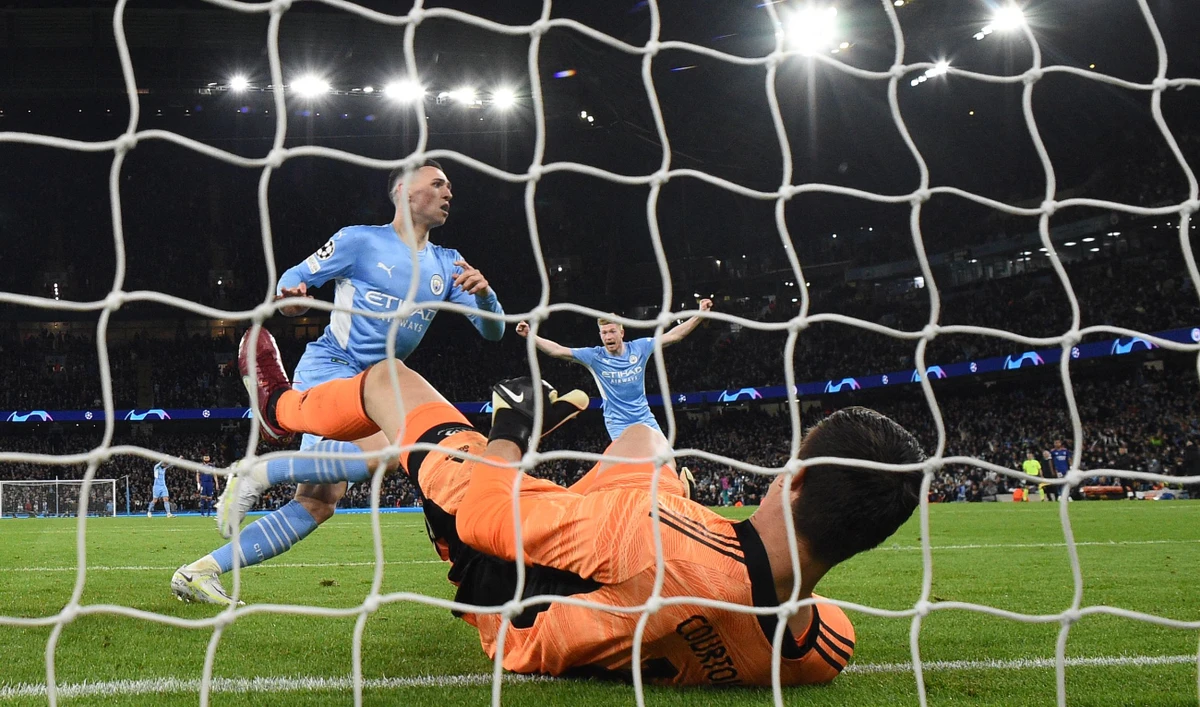 Manchester City's midfielder Phil Foden celebrates after scoring past Real Madrid's goalkeeper Thibaut Courtois during their UEFA Champions League semifinal first leg football match, on April 26, 2022. (AFP)