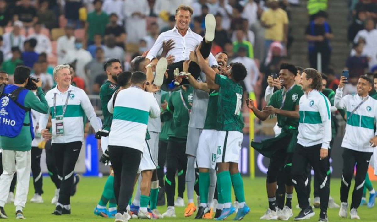 Saudi Arabia’s coach Herve Renard is carried by team players in celebration at the end of the 2022 FIFA World Cup Asian qualifiers match between Saudi Arabia and Australia on March 29, 2022. (AFP/File)