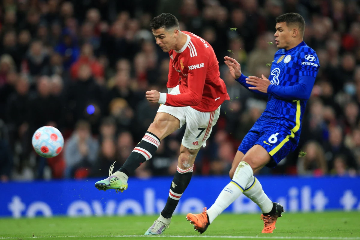 Manchester United's Cristiano Ronaldo shoots past Chelsea's Thiago Silva to score their first goal during the English Premier League football match in Manchester, England, on April 28, 2022. (AFP)