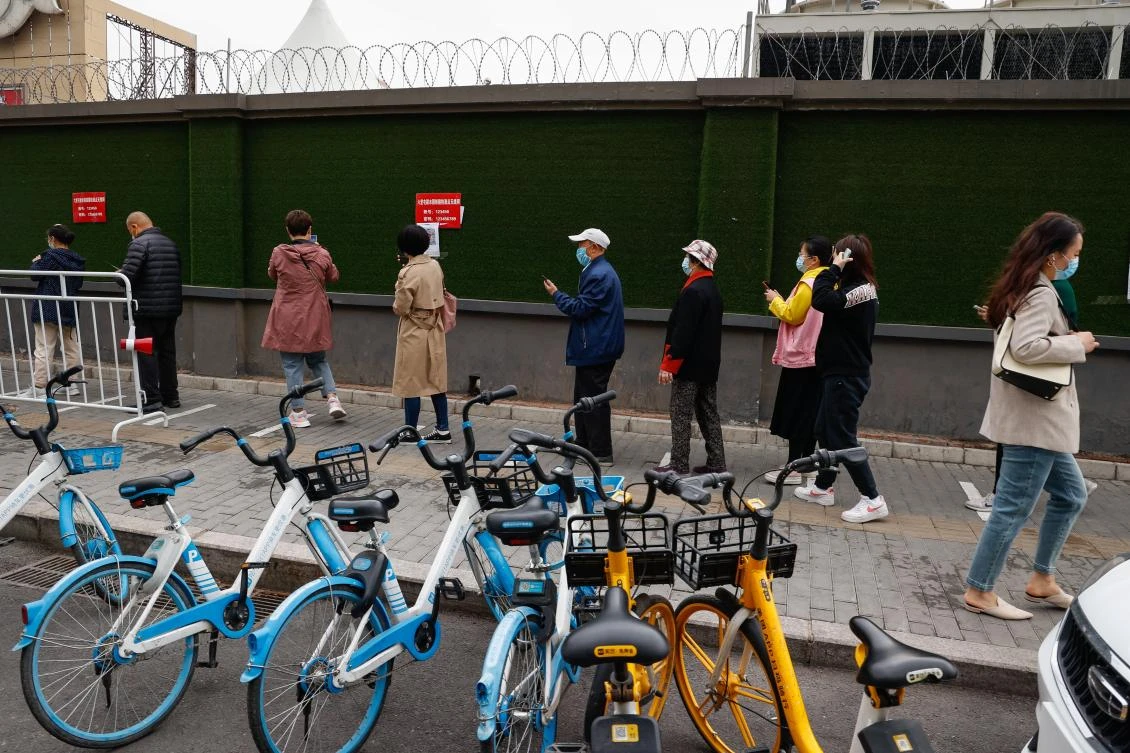 China reported over 10,700 coronavirus cases on Saturday, including asymptomatic ones. Above, residents queue lineup for a COVID-19 test near a train station in Beijing. (EPA)