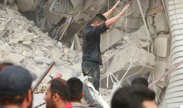 Rescue crews work at the site of a ten-story building collapse in Abadan, Iran, May 23, 2022. (Reuters)