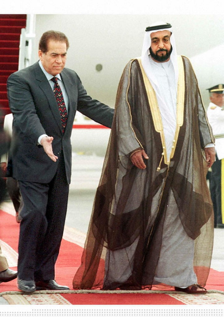 Sheikh Khalifa bin Zayed Al Nahyan (R), escorted by Egyptian Prime Minister Kamal Ganzuri, upon his arrival at Cairo airport for an official visit to Egypt in 1997. (AFP)