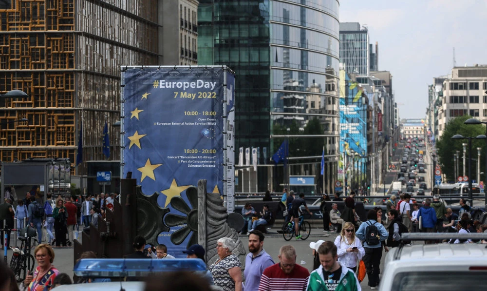 Pedestrians walk in Schuman Square during the European Union (EU) Open Day ahead of Europe Day in Brussels on May 7, 2022. (AFP)
