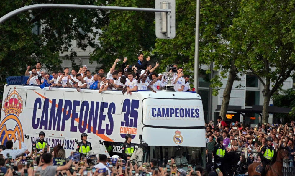 Real Madrid players celebrate on an open top bus after they won the Spanish La Liga title by defeating Espanyol in Madrid Saturday, April 30, 2022. (AP)