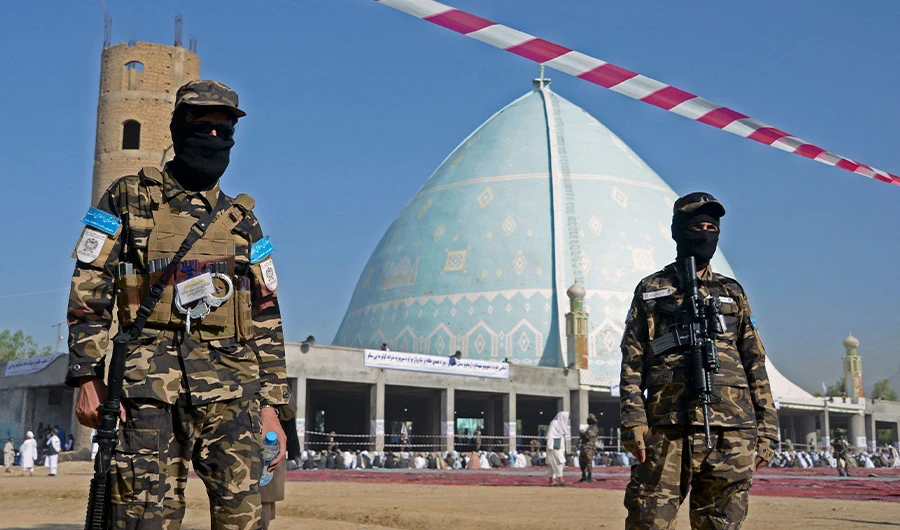 Taliban fighters stand guard as Muslim devotees prepare to offer Eid al-Fitr prayers, which marks the end of the holy fasting month of Ramadan at Eidgah in Kandahar on May 1, 2022. (AFP)
