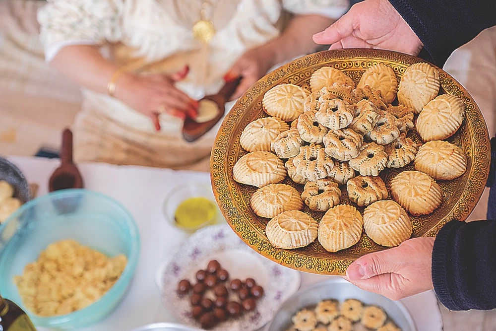 Families gorge on sweet treats such as mamool (main) during Eid. (Shutterstock)