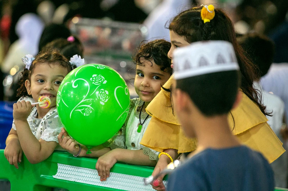 A muslim child holds a green balloon. (File/AFP)