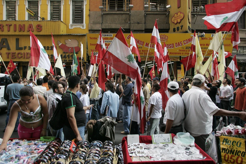 Members of the Lebanese community marching and waving flags in downtown Sao Paulo. (AFP)