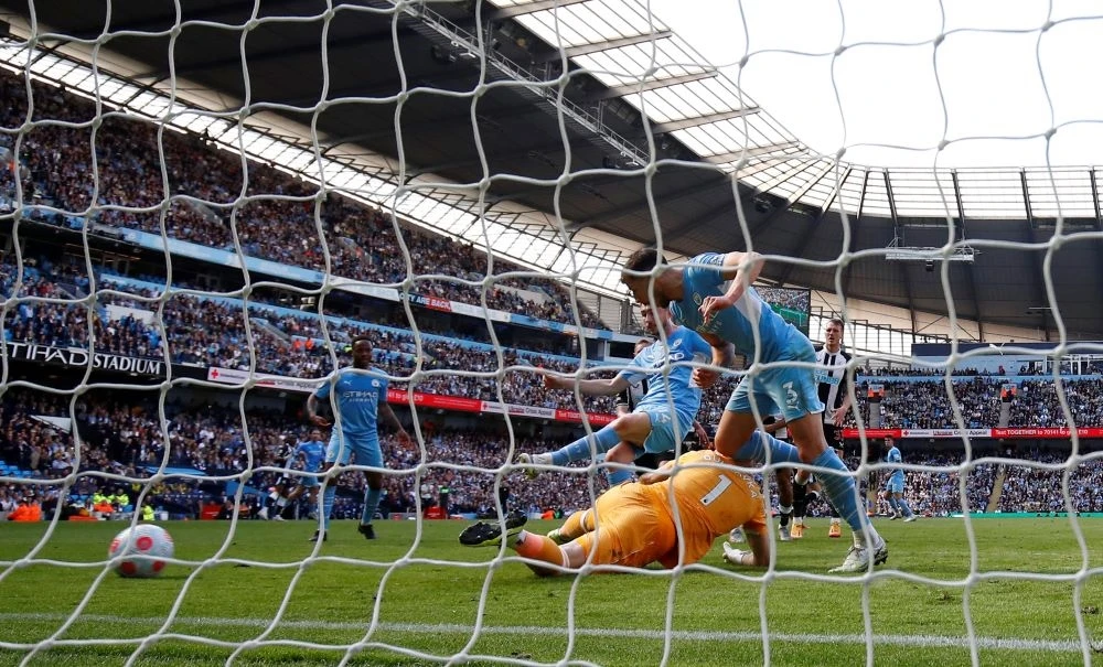 Aymeric Laporte, center, scores Manchester City’s second goal at the Etihad Stadium, Manchester, England, May 8, 2022. (Reuters)