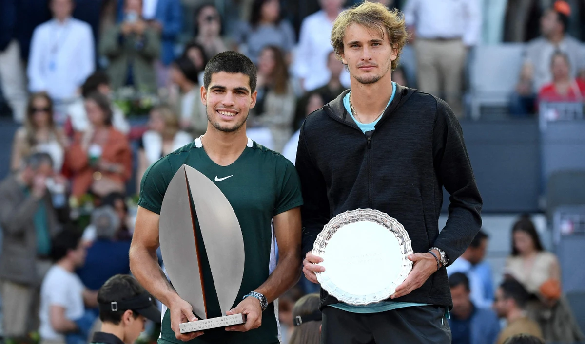 Spain's Carlos Alcaraz (L) with Germany's Alexander Zverev after winning the 2022 ATP Tour Madrid Open tennis tournament men's singles final match in Madrid on May 8, 2022. (AFP)